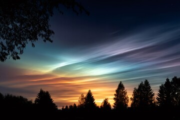 Polar stratospheric clouds shining over the forest at sunset