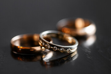 Close-up of Wedding Rings on a Dark Surface with Reflection..