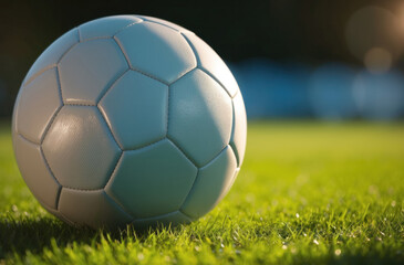 soccer ball resting on a lush vibrant green grass field, evoking imagery of sport leisure and outdoor activity.