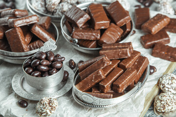 Assortment of sweet confectionery with chocolate candies and pralines. Children's holiday table with chocolate sweets
