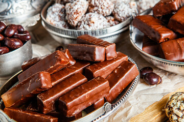 Assortment of sweet confectionery with chocolate candies and pralines. Children's holiday table with chocolate sweets