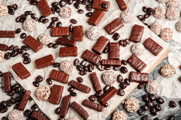 Assortment of sweet confectionery with chocolate candies and pralines. Children's holiday table with chocolate sweets