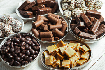 Assortment of sweet confectionery with chocolate candies and pralines. Children's holiday table with chocolate sweets