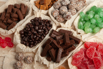 Assortment of sweet confectionery with chocolate candies and pralines. Children's holiday table with chocolate sweets