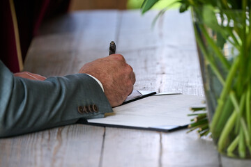 man writing on a paper