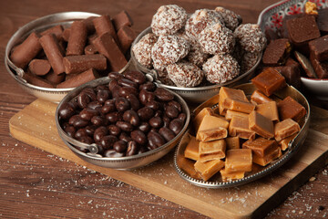 Assortment of sweet confectionery with chocolate candies and pralines. Children's holiday table with chocolate sweets