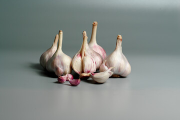 Fresh Garlic Bulb with Peeling Skins. purple garlic.  Suitable for cooking, health, food introduction, nutrition topics.
