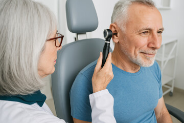 Senior Man Getting Ear Exam by Doctor
