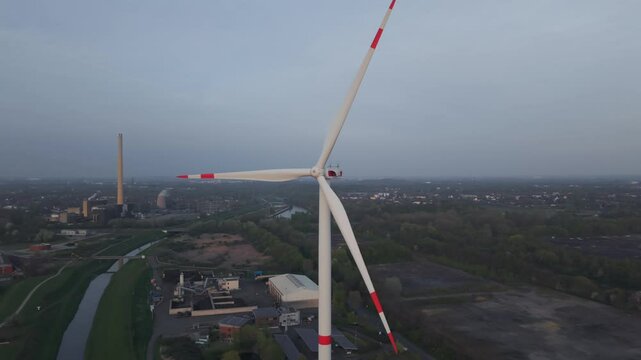 Windrad im Ruhrgebiet mit erkennbaren Energieerzeugern aus vergangenen Tagen im Hintergrund