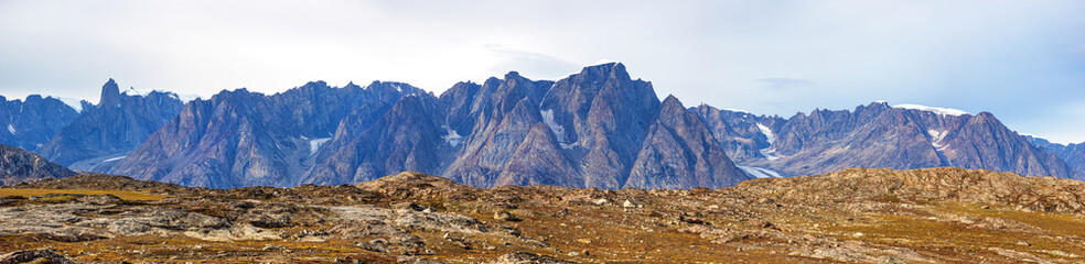 A panorama of the mountain range at Bear Islands, Northeast Greenland National Park, with the Grundtvigskirken mountain peak to the left. In Ofjord, Scoresby sound, Greenland