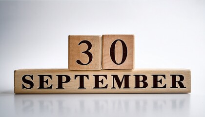 Fototapeta premium Minimalist photo of wooden blocks with date 30 September. Day and month, calendar on white background