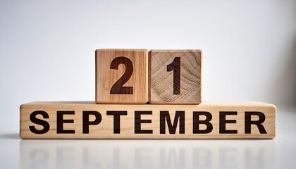 Minimalist photo of wooden blocks with date 21 September. Day and month, calendar on white background