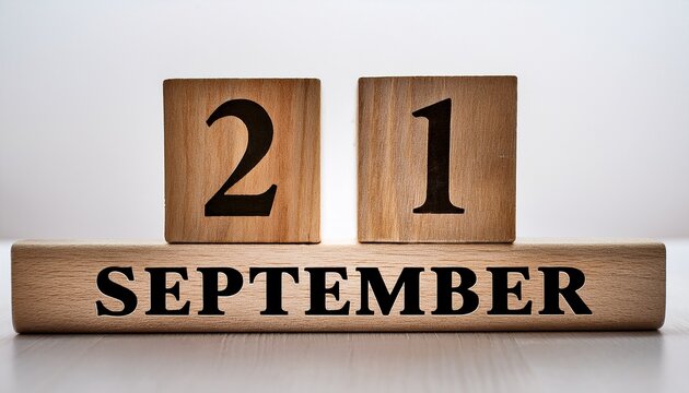 Minimalist photo of wooden blocks with date 21 September. Day and month, calendar on white background