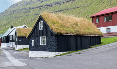 Traditional turf roof houses in Norgragota, Faroe Islands. Old church