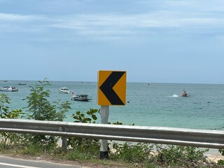 Road with chevron traffic signs in tropical Thailand