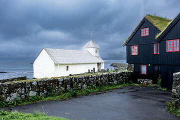 Saint Olav's Church in Kirkjubøur village. View for the old cemetery and back of the church