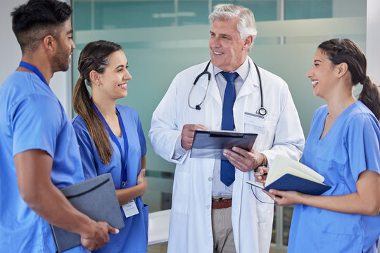 Healthcare, tablet or doctor with nurses at hospital for surgery schedule, planning or learning support. Clinic, teamwork or mature mentor surgeon with intern group for digital, checklist or teaching