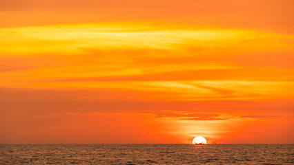Obraz premium Red Sunset, Sky clouds sun dawn over sea and fishing boat in the Evening with Orange, Yellow Gold sunlight in Golden hour and Dramatic fluffy, Horizon sea Summer sky landscape, Dusk sky background