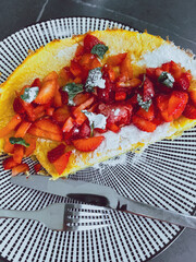 Breakfast with Dutch baby pancake, fresh strawberries, and mint. Classic morning treat, cozy brunch vibes, perfect for food styling and blogs
