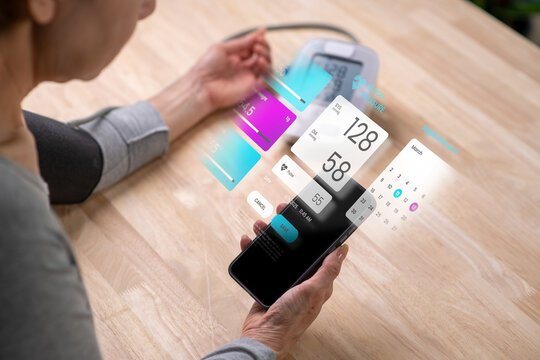 Senior Asian Woman taking blood pressure test on phone, in concept of Augmented reality, Application Interface design, UX UI design, and Health care - Powered by Adobe