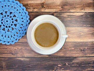 Cup of coffee and crocheted doily mandala photo