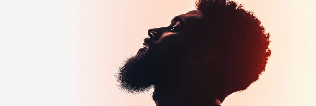 Silhouette of a bearded man with a fade effect on a clean white background at dusk