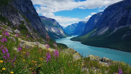 A breathtaking high-angle view of a Norwegian fjord valley with lush greenery and vibrant purple flowers.