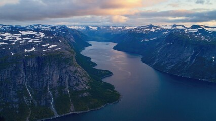 Fototapeta premium Waterway surrounded by snowy mountains.