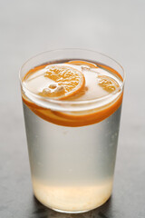 organic lemonade in tumbler glass on concrete background