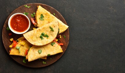 Delicious quesadilla with fresh vegetables served with tomato sauce