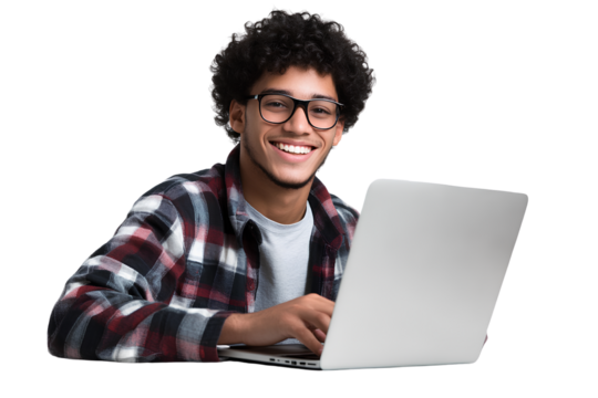 A happy young man with glasses and curly hair is sitting at a table in front of his laptop, against a transparent background
