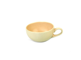 Empty beige mug of coffee or tea isolated on a white background. Use for home or restaurant, food design. Concept kitchen utensils and tableware. Side view...