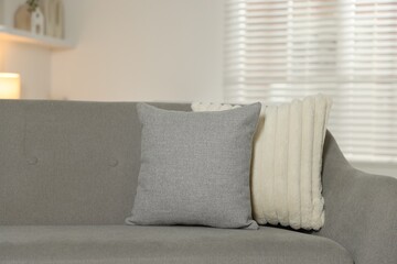 Soft decorative pillows on sofa in room