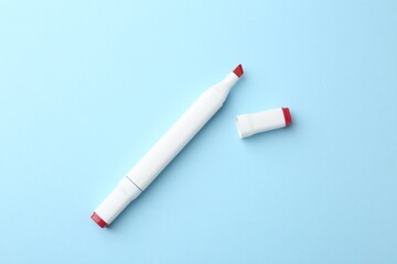 One color double sided marker on light blue background, top view