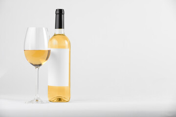 Tasty wine in glass and bottle on white background, space for text