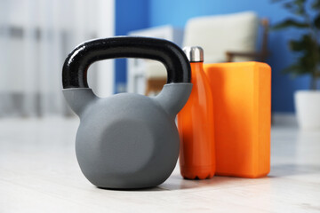Kettlebell and other sports equipment on floor indoors