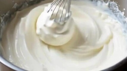Whipping cream in a mixing bowl until fluffy - Powered by Adobe