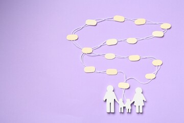 Family tree made with bubbles and people figure on lilac background, top view