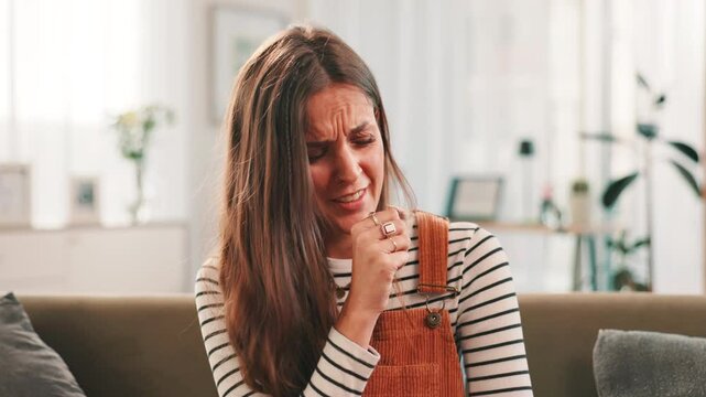 Sick, woman or coughing with illness on sofa for chest pain, asthma or respiratory infection at home. Female person, cold or flu with symptoms of virus for pneumonia, bronchitis or allergies at house