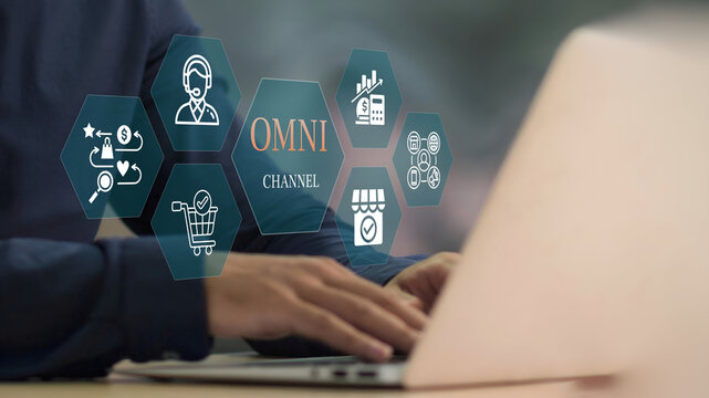 A business person using laptop with Omni Channel Digital Marketing and E-Commerce concept.