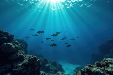 Fototapeta premium Silent school of fish swimming beneath the dark blue ocean surface, fish, aquatic animals, ocean movement