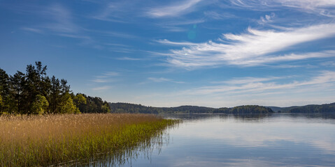 A lake with a cloudy sky in the background