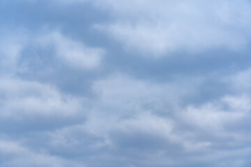 Cloudy sky with various shades of blue and gray covering the horizon