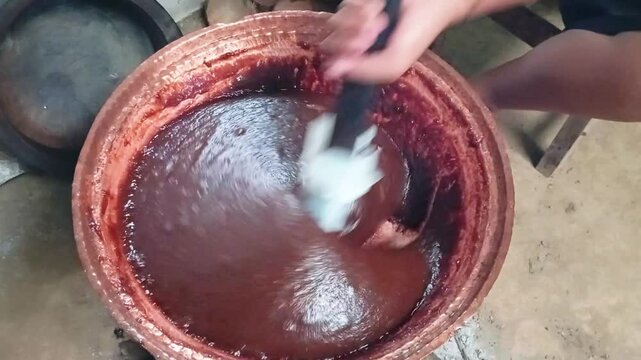 making jenang or dodol, a traditional Javanese food made from rice flour and brown sugar
