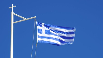 National flag of Greece flying in a strong breeze; photo taken at Chania on the island of Crete