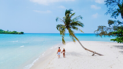A loving couple strolls handinhand along the stunningly beautiful beaches of Koh Kood Island...