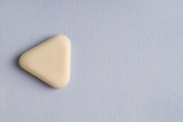 One eraser on grey background, top view. Space for text