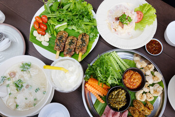 Northern Thai spicy green chilli dip with sausage and crackling with vegetable set on banana leaf. Minced pork porridge is traditional Thai food