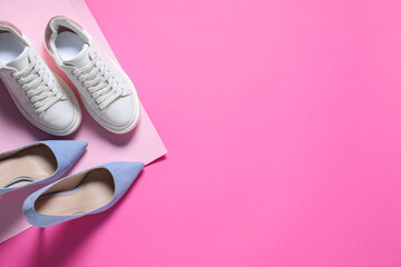 High heeled shoes and sneakers on pink background, flat lay. Space for text