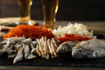 Different dried fish on wooden table, closeup